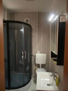 a bathroom with a shower and a sink at Ralin Apart in Prizren