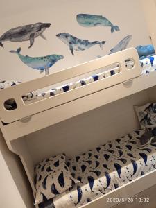 a bedroom with a bunk bed with a dolphin wall at Acquario Inn Genova House in Genoa