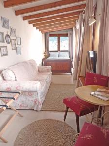 a living room with a couch and a table and a bed at Old-Town Roof-Garden Suite in Kavala
