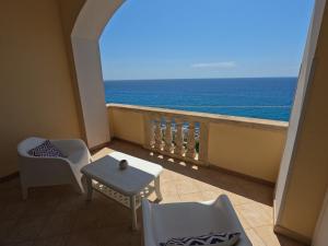 a balcony with a view of the ocean at B&B The Sun 'tis in Castro di Lecce