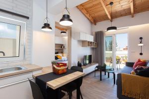 a kitchen and living room with a table and a couch at Cactopia Apartments- Hoya-Stapelia-Aeonium in Rethymno