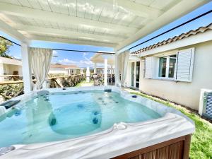 a hot tub in the backyard of a house at Ville d'Ogliastra 2 - Marina Suites in Cardedu