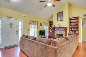 a large couch in a living room with a fireplace at Georgia Vacation Rental 14 Mi to Downtown Augusta in Hephzibah