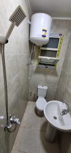 a small bathroom with a toilet and a sink at ستوديو على البحر محطة الرمل Raml station stodeo in Alexandria