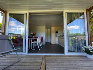 a large sliding glass door on a patio with a table at International Camping Ardèche in Salavas