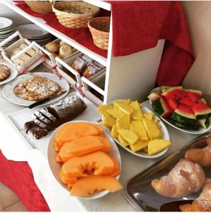 a table filled with different types of food on plates at B&B Gattopardo in Cariati