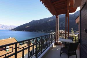 a balcony with a view of the water and mountains at Bellezza Resort & SPA in Kotor