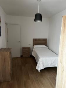 Posteľ alebo postele v izbe v ubytovaní Apartamento Arenas