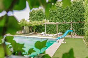 a swimming pool with a slide and a playground at Casas Mancha in Torrenueva