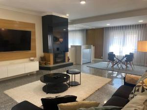 a living room with a couch and a tv at Casa da Luna in Matosinhos