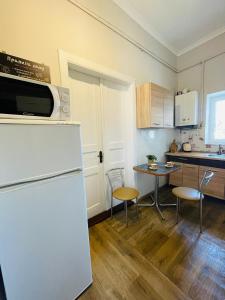 リヴィウにあるДжерельна 25, апартаменти в центрі з двома ізольованими спальнямиのキッチン(冷蔵庫、テーブル、椅子付)
