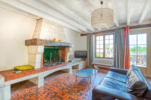 a living room with a fireplace and a couch at Gîte Monkey cottage in Bouchemaine