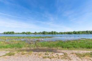 a large body of water with trees in the background at Beau STUDIO vue LOIRE in Bouchemaine