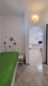 a bedroom with a green bed in a room at BILO EGADI E MONO EGADI in Favignana