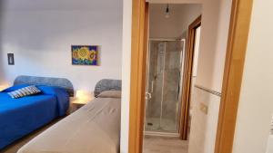 a bedroom with a bed and a door to a bathroom at BILO EGADI E MONO EGADI in Favignana +2 photos