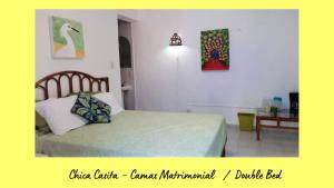 a bedroom with a bed and a table with a lamp at Dos Casitas Tranquilo in Progreso