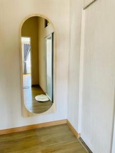 a mirror on a wall in a room at MiUon House R in Ấp Ða Lợi