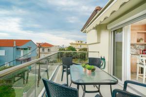 a balcony with a table and chairs and a view at Dagos Luxury Apartments in Limenas