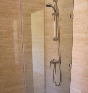 a shower with a glass door in a bathroom at BEL APPART FONCTIONNEL PRESTIGIA GOLF MARRAKECH in Marrakesh