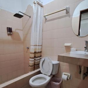 y baño con aseo, bañera y lavamanos. en Apartamento Bizantino en Cozumel