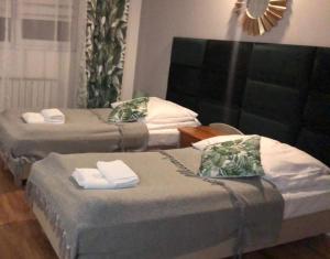 Un pat sau paturi într-o cameră la Zajazd Tumidaj
