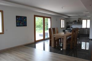 a kitchen and dining room with a table and chairs at Chez Lily et Bruno in Morbier