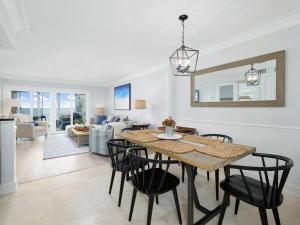 a dining room and living room with a table and chairs at El Mar in Ponte Vedra Beach