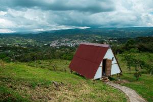 a small house on top of a hill at Glamping brisa de guadua in Moniquirá