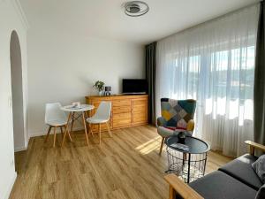 a living room with a couch and a table at zum Schwanen Garni in Buggingen