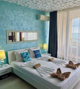 a bedroom with a large bed with towels on it at Свети Зосим in Sozopol