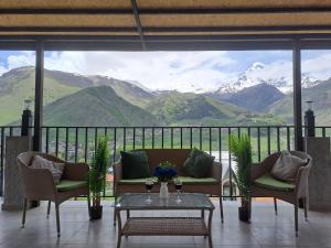 a living room with a view of a mountain at Prime Hotel Kazbegi in Stepantsminda