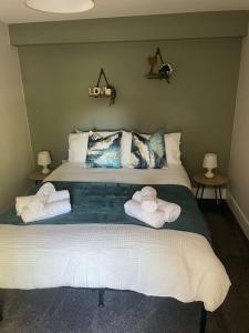 a bedroom with a bed with towels on it at Poplar House-2Bedroom house in town centre with free Parking by ShortStays4U in King's Lynn