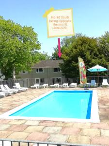 a sign next to a swimming pool with a sign at 2 bed Villa with full use of site facilities in Newquay