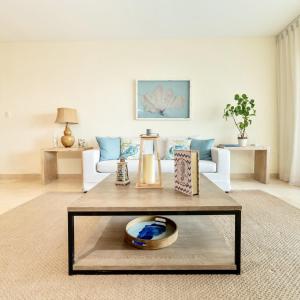 a living room with a couch and a coffee table at New! Beachfront Lux Condo With Private Jacuzzi in Punta Cana