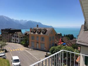 a view from the balcony of a town with the ocean at New appartment Design Montreux in Montreux
