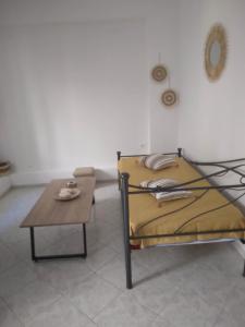 a bed and a coffee table in a room at RIVER SIDE HOUSE in Potámion