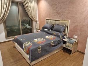 a bedroom with a bed with a colorful comforter at THE luxurious and romantic pearl apartment in Mohammedia