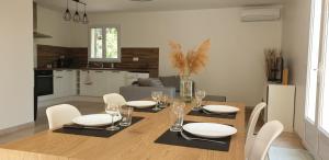 una sala da pranzo e una cucina con tavolo e sedie di Une maison en Provence a Pierrevert