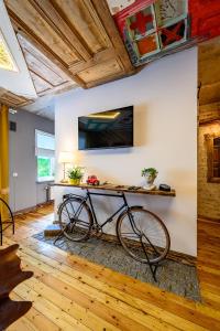 a bike is parked in a room with a wall at Arthouse Narnia in Liepāja
