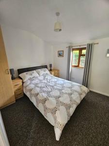 a bedroom with a large bed and a window at Picturesque Cabin in Cornwall in Camborne