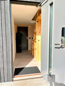 a hallway of a house with a door open at Neptuni Bed and Kitchen in Varberg