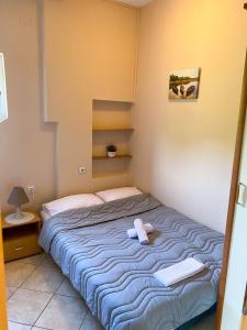 a bedroom with a bed with a stuffed animal on it at Apartments Rade Bigovo in Tivat