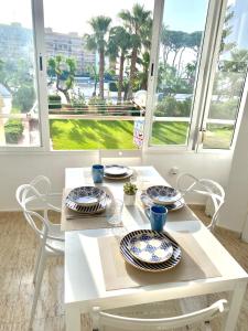 a white table with blue and white plates on it at New! Seaview-Vistas al Mar con Piscina en La Pineda in La Pineda