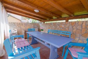 a blue table and chairs on a patio at Ivana C6 in Veli Lošinj