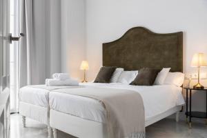 En eller flere senge i et værelse på San Buenaventura Apartment 3