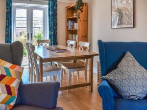 a dining room with a wooden table and chairs at Ellies Nook in Ireby