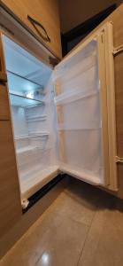 an empty refrigerator with its door open in a kitchen at Casa Elena in Torvaianica