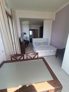 a hotel room with a bed and two chairs at Cala Dei Mori in Livorno