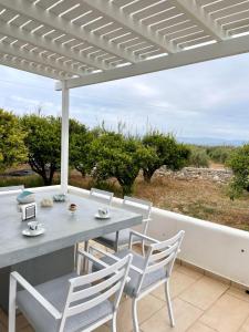 a table and chairs on a patio with a view at RIZES ELIAS HOUSE in Isterni