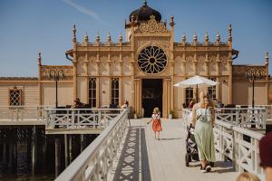 a woman and a little girl walking across a bridge at Neptuni Bed and Kitchen in Varberg +22 photos